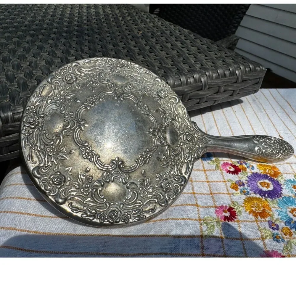 Vintage silver tone hand mirror embossed design on back so pretty